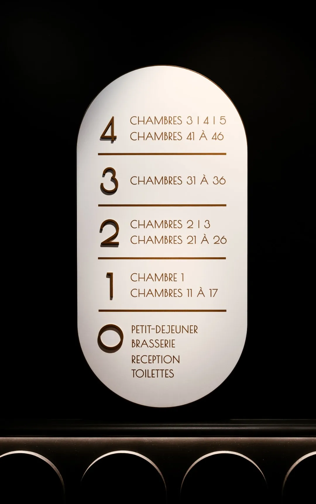 Signalétique des étages : arche blanche, lettrage cuivré